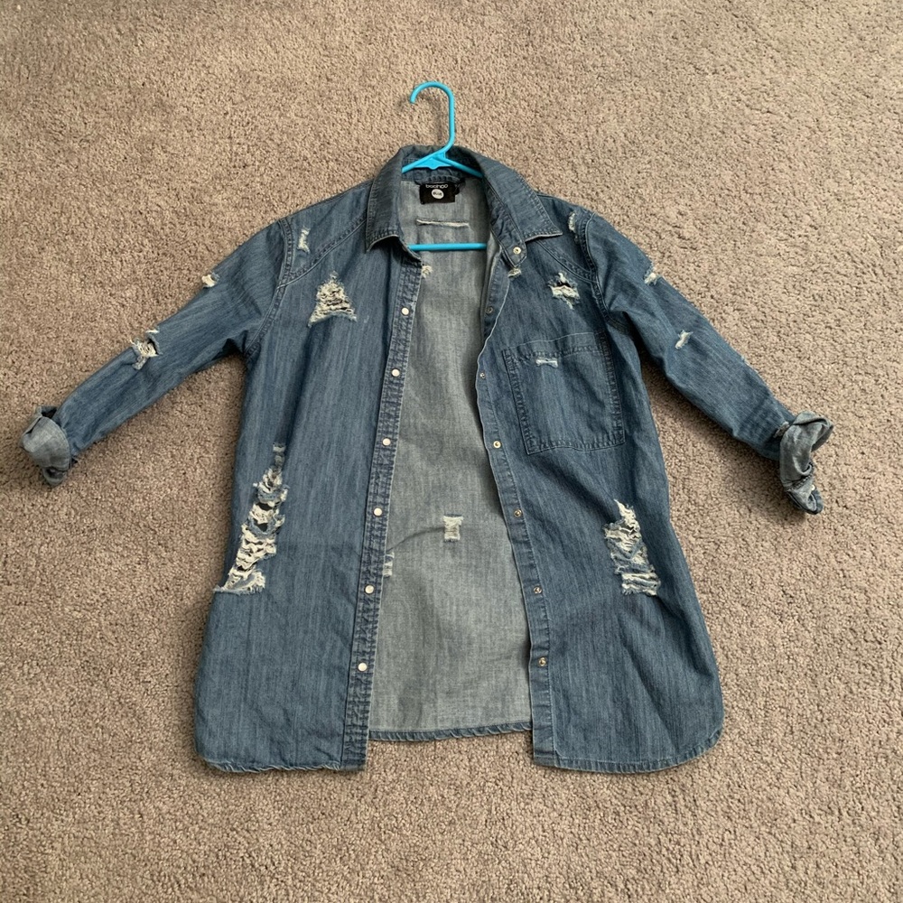 Distressed denim shirt.